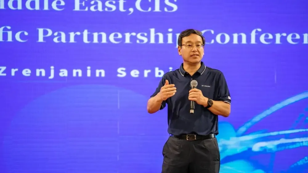 Feng Wang, CEO and President of Linglong Tire talking at an event with a blue background