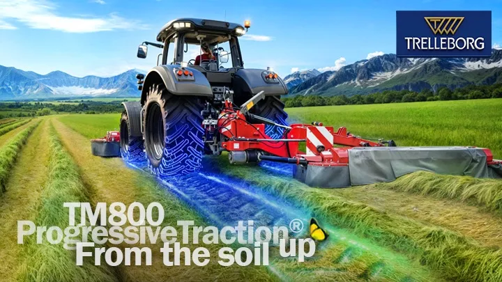 Tractor ploughing in a green field, view from behind