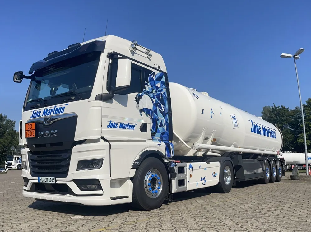 Johannes Martens branded oil tanker in white parked with a blue sky background.