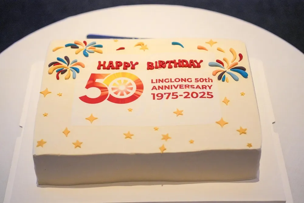 Image of Linglong Tire 50th Event Birthday Cake with white icing and red writing