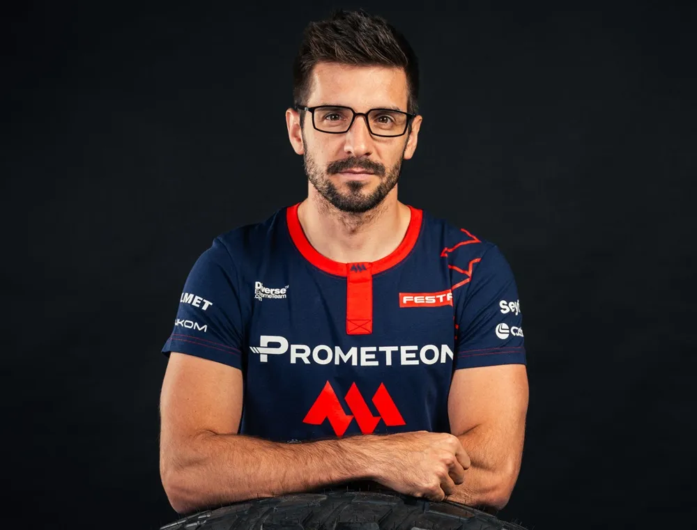 Image of Martin Macík Jr. on a black background wearing a blue top with red detailing