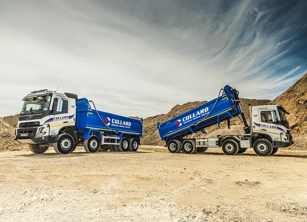 Image of two blue Collard Group trucks side view facing opposite ways